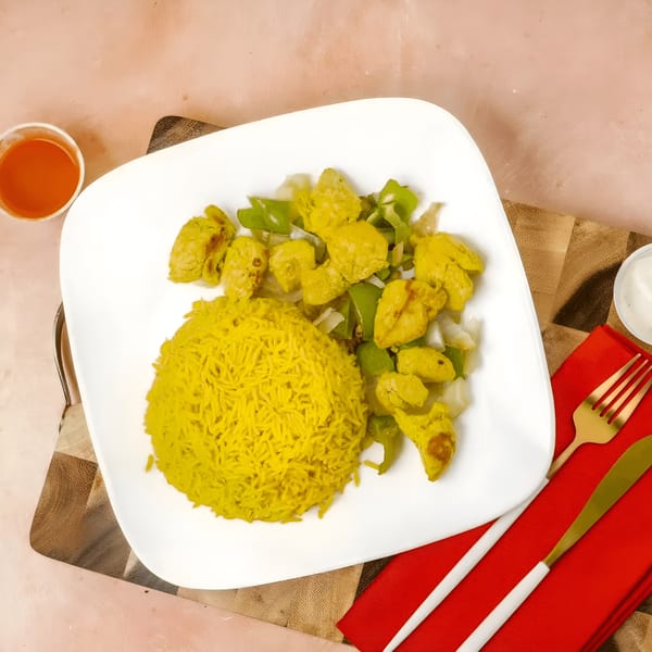 Snappers' yellow rice and chicken with green peppers and onions, with hot sauce and dipping sauce.